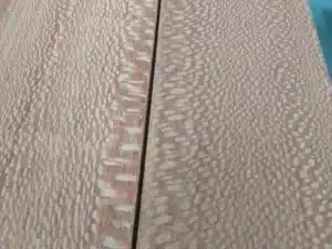 Close-up view of pommele sapele wood boards with distinctive quilted grain pattern