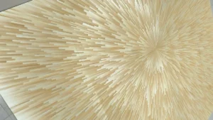 Close-up of a sunburst radial pattern made from light wheat straw veneer strips, forming a decorative wall panel in neutral tones.